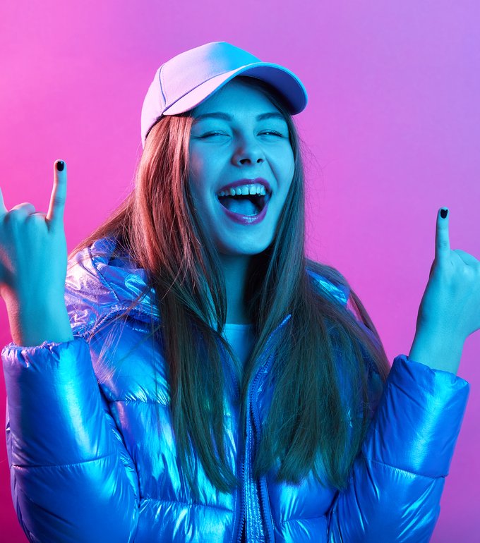 happy-excited-woman-showing-rock-gesture-with-fingers